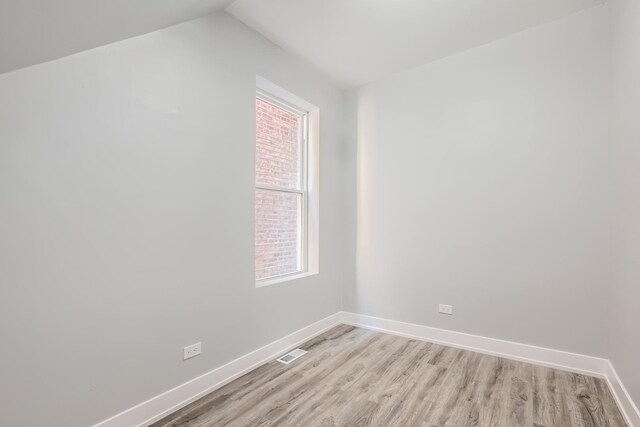 5359 S Marshfield Ave, Chicago, IL 60609 - empty room featuring light wood-style flooring and lofted ceiling