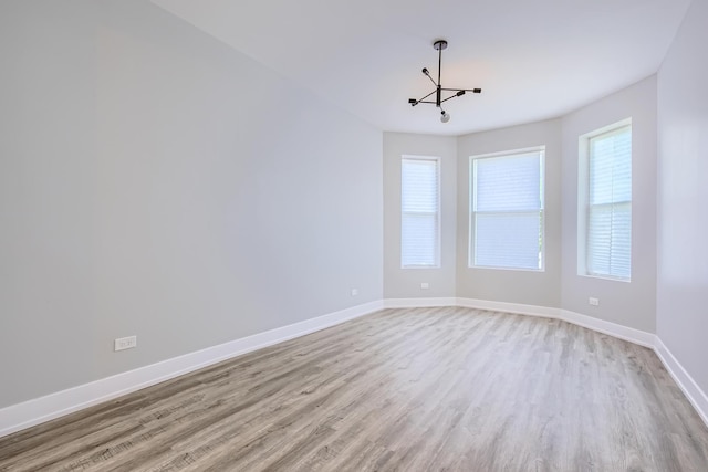 5359 S Marshfield Ave, Chicago, IL 60609 - spare room with plenty of natural light, light wood finished floors, and a chandelier
