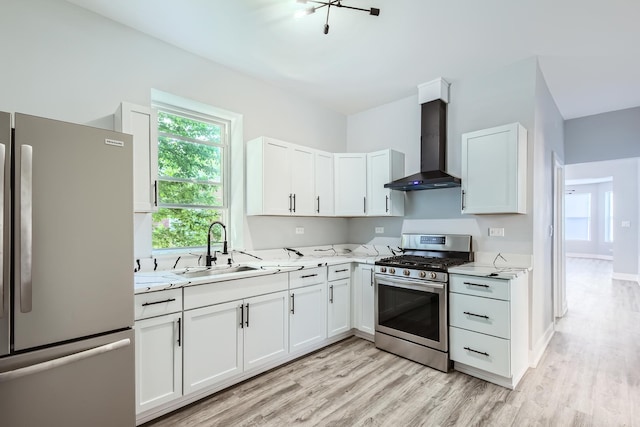 5359 S Marshfield Ave, Chicago, IL 60609 - kitchen featuring appliances with stainless steel finishes, wall chimney range hood, light wood-type flooring, and white cabinets