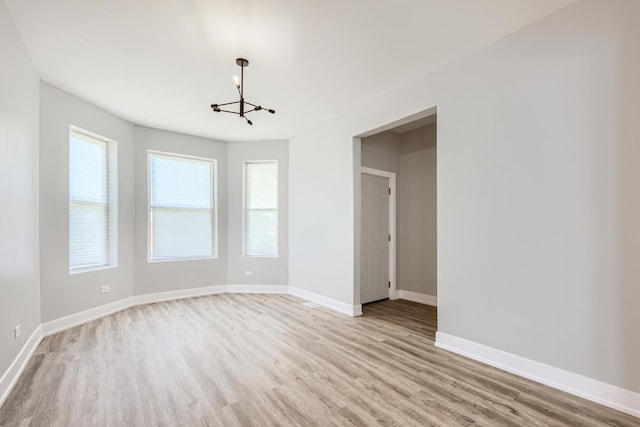 5359 S Marshfield Ave, Chicago, IL 60609 - unfurnished room with a chandelier and light wood-style flooring