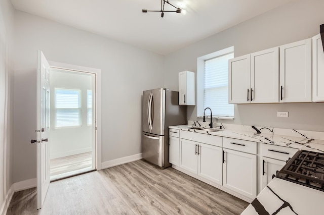 5359 S Marshfield Ave, Chicago, IL 60609 - kitchen featuring freestanding refrigerator, healthy amount of natural light, white cabinets, and light wood-style floors