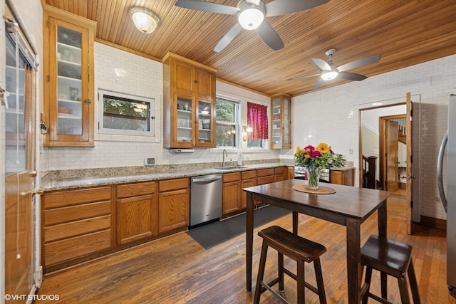 710 W Downer Pl, Aurora, IL 60506 - kitchen featuring appliances with stainless steel finishes, wooden ceiling, brown cabinets, a ceiling fan, and dark wood finished floors
