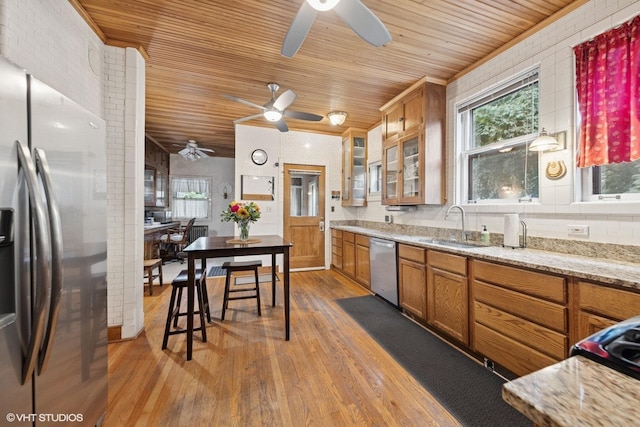 710 W Downer Pl, Aurora, IL 60506 - kitchen with appliances with stainless steel finishes, ceiling fan, wooden ceiling, brown cabinetry, and healthy amount of natural light