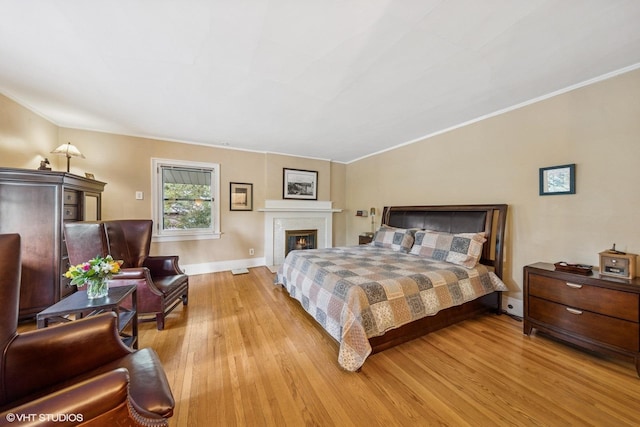 710 W Downer Pl, Aurora, IL 60506 - bedroom featuring wood finished floors, ornamental molding, and a fireplace