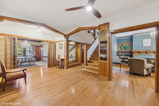 710 W Downer Pl, Aurora, IL 60506 - living area featuring wood finished floors, a chandelier, stairs, and a ceiling fan