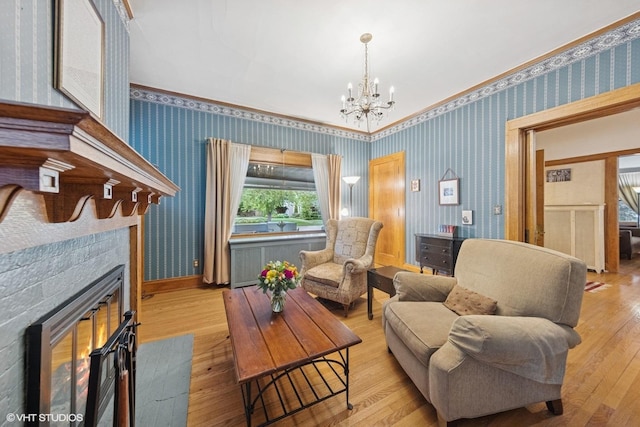 710 W Downer Pl, Aurora, IL 60506 - sitting room featuring wallpapered walls, hardwood / wood-style flooring, a chandelier, a fireplace with flush hearth, and ornamental molding