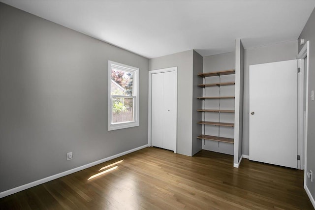 22255 Merrill Ave, Sauk Village, IL 60411 - unfurnished bedroom featuring wood finished floors and a closet