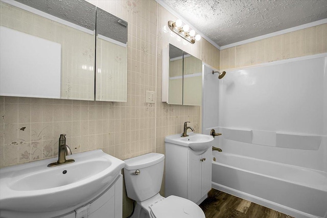 22255 Merrill Ave, Sauk Village, IL 60411 - bathroom featuring a textured ceiling, wood finished floors, shower / washtub combination, vanity, and decorative backsplash