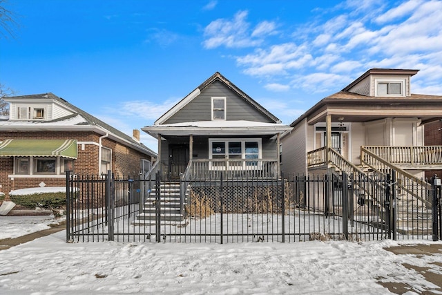 8545 S Saginaw Ave, Chicago, IL 60617 - shotgun-style home featuring a porch, stairway, and a fenced front yard