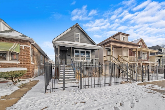 8545 S Saginaw Ave, Chicago, IL 60617 - shotgun-style home featuring a porch, a fenced front yard, stairs, and brick siding