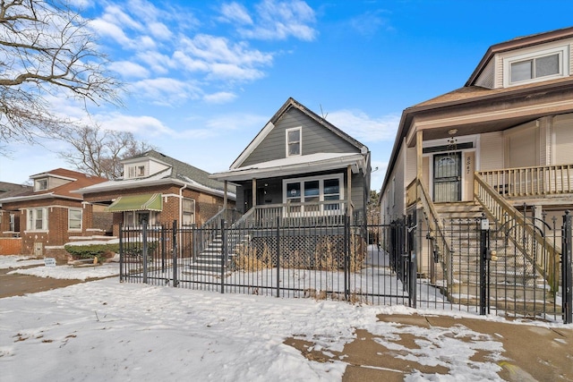 8545 S Saginaw Ave, Chicago, IL 60617 - shotgun-style home with a porch, a fenced front yard, and stairs