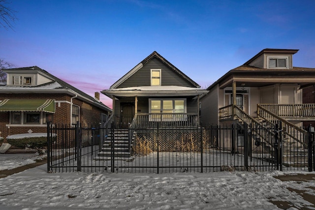 8545 S Saginaw Ave, Chicago, IL 60617 - shotgun-style home featuring a porch, stairway, and a fenced front yard