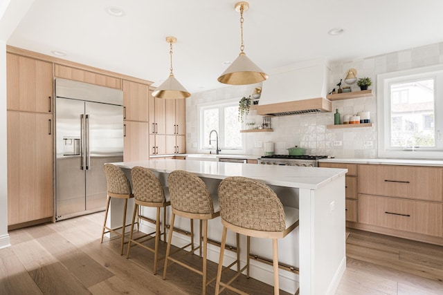 438 Hill Ave, Glen Ellyn, IL 60137 - kitchen with built in refrigerator, custom exhaust hood, light brown cabinets, open shelves, and light wood-type flooring