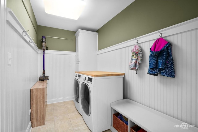 438 Hill Ave, Glen Ellyn, IL 60137 - washroom featuring washer and dryer, a wainscoted wall, light tile patterned floors, and cabinet space