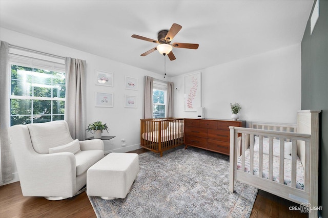 438 Hill Ave, Glen Ellyn, IL 60137 - bedroom with wood finished floors, a crib, and a ceiling fan