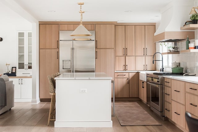 438 Hill Ave, Glen Ellyn, IL 60137 - kitchen with light brown cabinets, premium appliances, open shelves, light countertops, and custom range hood