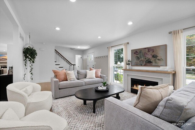 438 Hill Ave, Glen Ellyn, IL 60137 - living room featuring stairs, a warm lit fireplace, recessed lighting, and wood finished floors