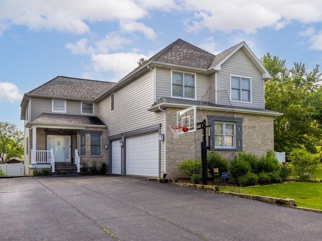 1213 Prairie Ave, Barrington, IL 60010 - traditional home with an attached garage, driveway, brick siding, and roof with shingles