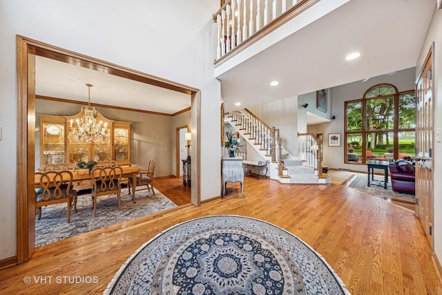 3104 Royal Fox Dr, Saint Charles, IL 60174 - foyer with stairs, wood finished floors, a chandelier, crown molding, and a towering ceiling