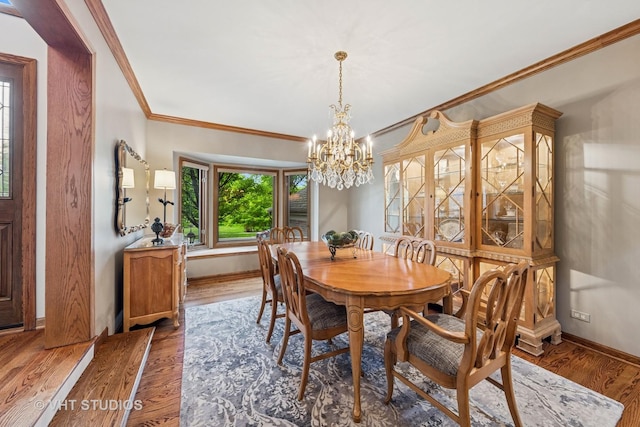 3104 Royal Fox Dr, Saint Charles, IL 60174 - dining space featuring a chandelier, wood finished floors, and crown molding