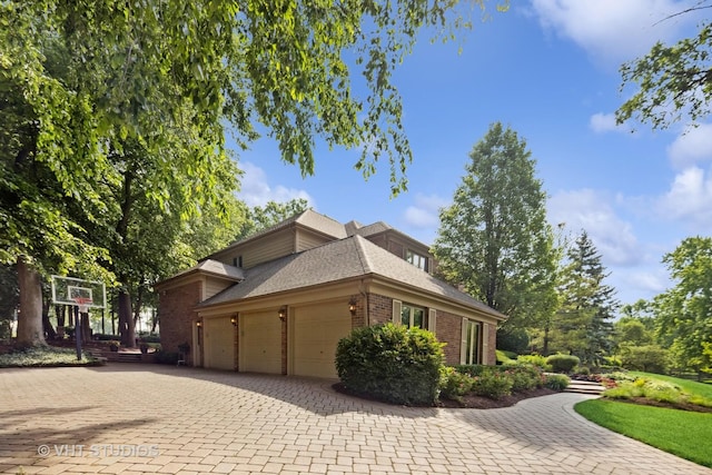 3104 Royal Fox Dr, Saint Charles, IL 60174 - view of home's exterior featuring brick siding, an attached garage, decorative driveway, and roof with shingles