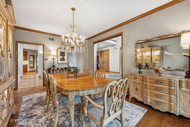 3104 Royal Fox Dr, Saint Charles, IL 60174 - dining room with a chandelier, wood finished floors, and ornamental molding