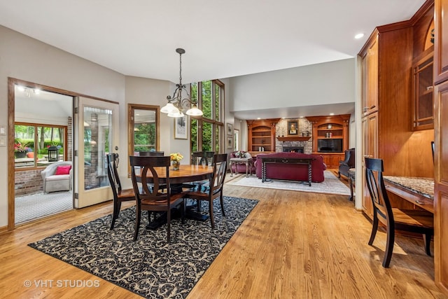 3104 Royal Fox Dr, Saint Charles, IL 60174 - dining space with a fireplace, light wood-style flooring, a chandelier, and recessed lighting