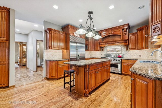 3104 Royal Fox Dr, Saint Charles, IL 60174 - kitchen with premium appliances, a kitchen island, light wood finished floors, stone counters, and recessed lighting