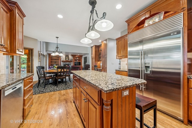 3104 Royal Fox Dr, Saint Charles, IL 60174 - kitchen featuring stainless steel appliances, light wood-style floors, brown cabinetry, and recessed lighting
