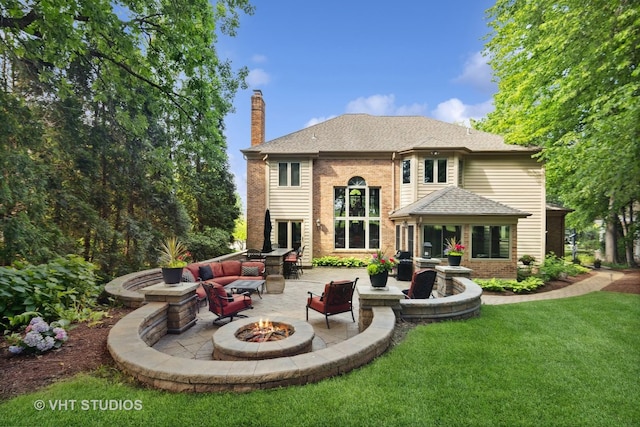 3104 Royal Fox Dr, Saint Charles, IL 60174 - rear view of house featuring a fire pit, a patio, a chimney, a lawn, and brick siding