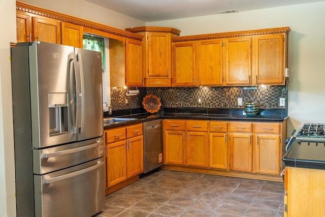1702 E State St, Rockford, IL 61104 - kitchen with stainless steel appliances, brown cabinets, and backsplash