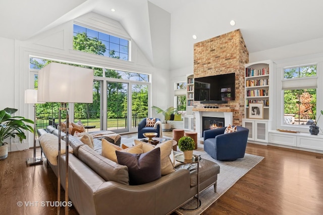 1200 Green Bay Rd, Glencoe, IL 60022 - living area featuring wood finished floors, high vaulted ceiling, a brick fireplace, and healthy amount of natural light