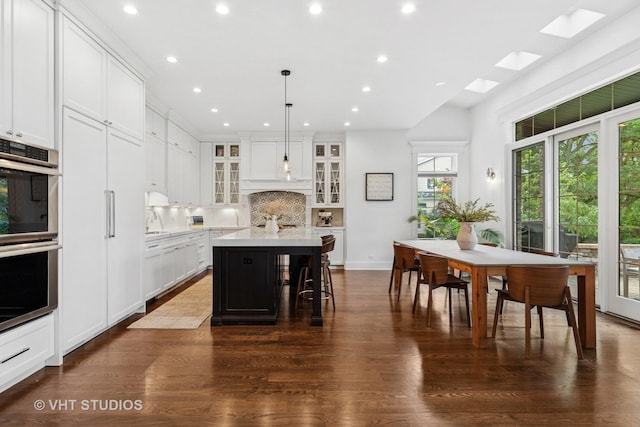 1200 Green Bay Rd, Glencoe, IL 60022 - kitchen featuring tasteful backsplash, recessed lighting, a kitchen island, glass insert cabinets, and light countertops