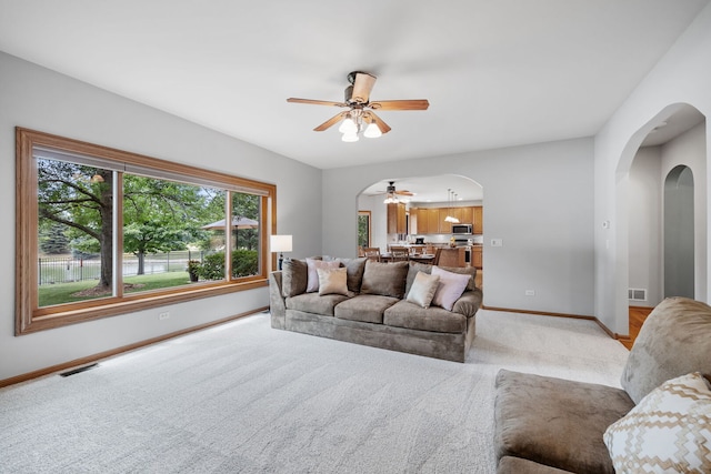 2717 Meadow Path, New Lenox, IL 60451 - living area with arched walkways, ceiling fan, and light colored carpet