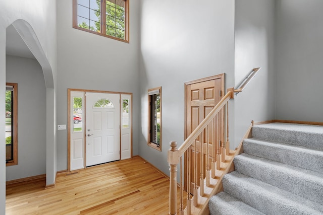2717 Meadow Path, New Lenox, IL 60451 - foyer with arched walkways, a towering ceiling, and wood finished floors