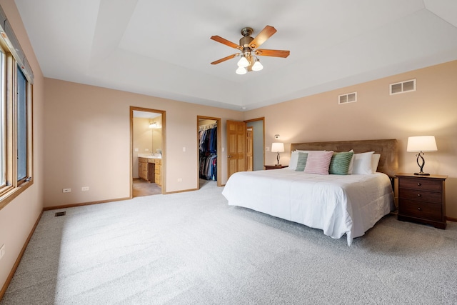 2717 Meadow Path, New Lenox, IL 60451 - bedroom featuring light colored carpet, a walk in closet, a tray ceiling, and ensuite bath