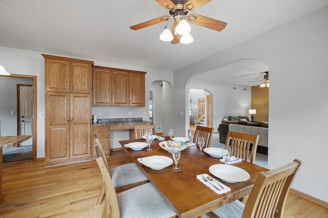 2717 Meadow Path, New Lenox, IL 60451 - dining space featuring a ceiling fan, arched walkways, and light wood-style flooring