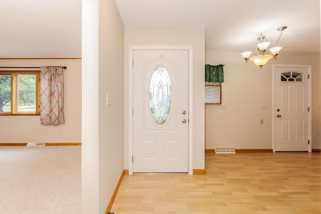 1316 Kirkwood Dr, Pontiac, IL 61764 - foyer featuring a chandelier and light wood finished floors