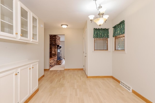 1316 Kirkwood Dr, Pontiac, IL 61764 - corridor with light wood-style flooring and a chandelier