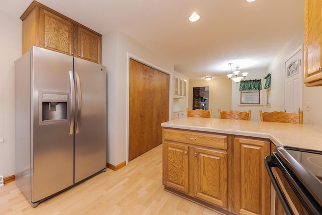 1316 Kirkwood Dr, Pontiac, IL 61764 - kitchen with appliances with stainless steel finishes, light wood finished floors, brown cabinetry, a chandelier, and recessed lighting
