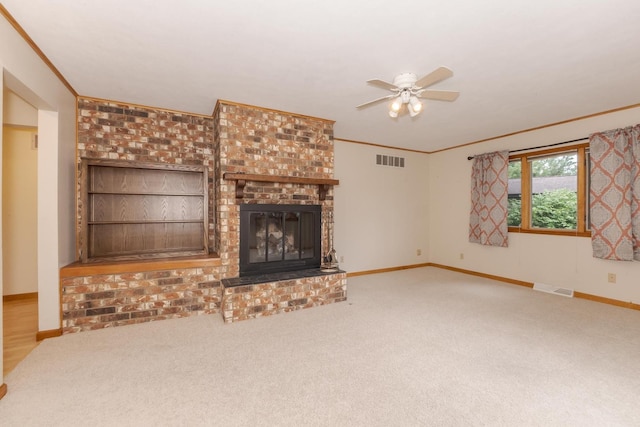 1316 Kirkwood Dr, Pontiac, IL 61764 - unfurnished living room with crown molding, ceiling fan, a brick fireplace, and carpet floors