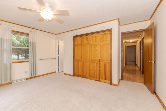 1316 Kirkwood Dr, Pontiac, IL 61764 - unfurnished bedroom featuring light colored carpet, crown molding, a closet, and a ceiling fan