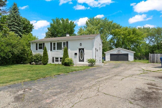 2116 Castle Ct, Waukegan, IL 60087 - raised ranch with a garage, an outbuilding, a front lawn, and a chimney