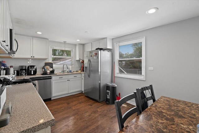 2116 Castle Ct, Waukegan, IL 60087 - kitchen featuring appliances with stainless steel finishes, dark wood-style flooring, backsplash, white cabinetry, and recessed lighting