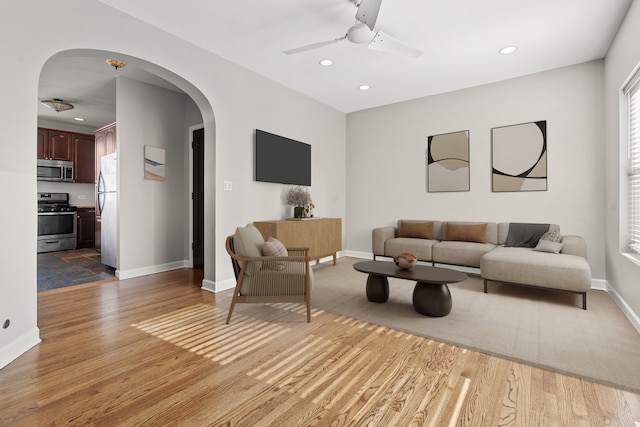7438 N Hermitage Ave Unit 1E, Chicago, IL 60626 - living area with arched walkways, light wood-type flooring, ceiling fan, healthy amount of natural light, and recessed lighting