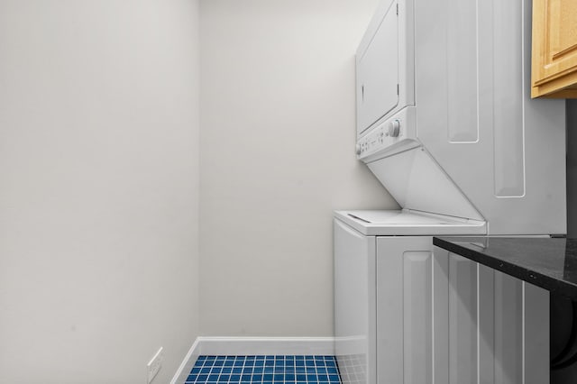 7438 N Hermitage Ave Unit 1E, Chicago, IL 60626 - laundry room with stacked washer / drying machine, cabinet space, and tile patterned flooring