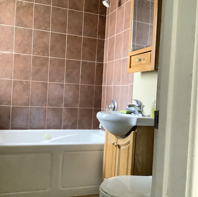 8008-8010 S Honore St, Chicago, IL 60620 - bathroom featuring vanity, tile walls, and washtub / shower combination