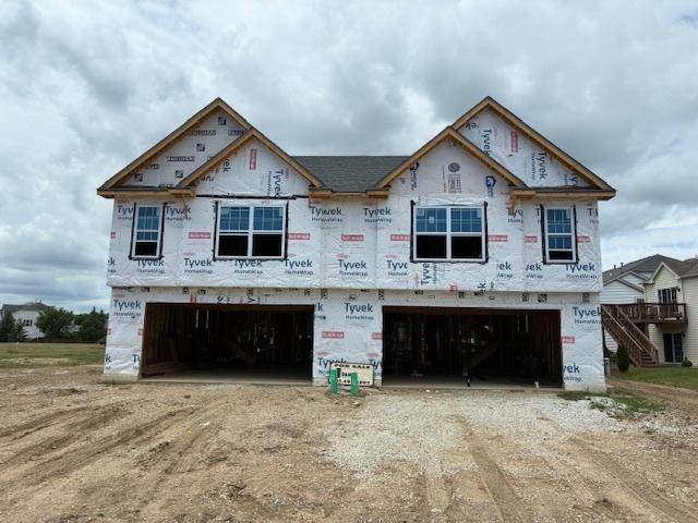 939 Saddle Ridge Dr, Joliet, IL 60432 - property under construction with an attached garage and dirt driveway