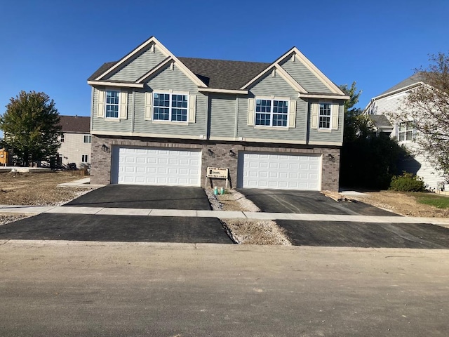 939 Saddle Ridge Dr, Joliet, IL 60432 - view of front of property featuring a garage, driveway, and brick siding