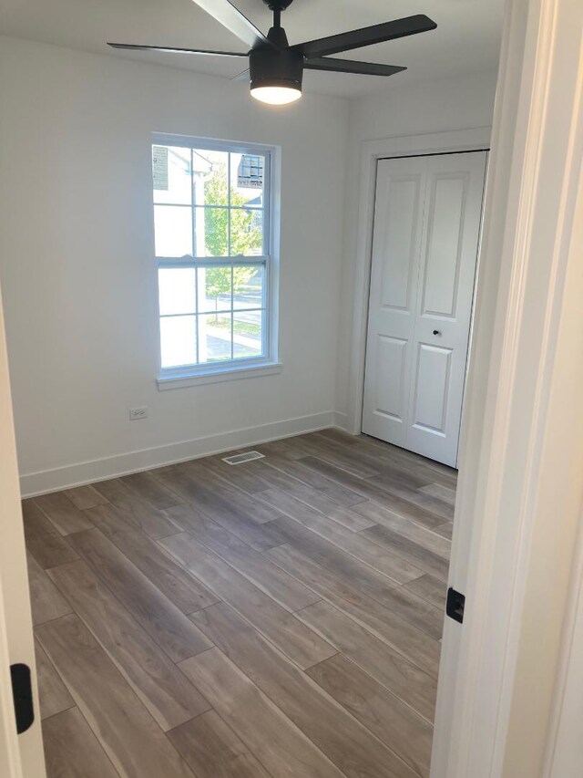 939 Saddle Ridge Dr, Joliet, IL 60432 - unfurnished bedroom featuring wood finished floors, a closet, and ceiling fan
